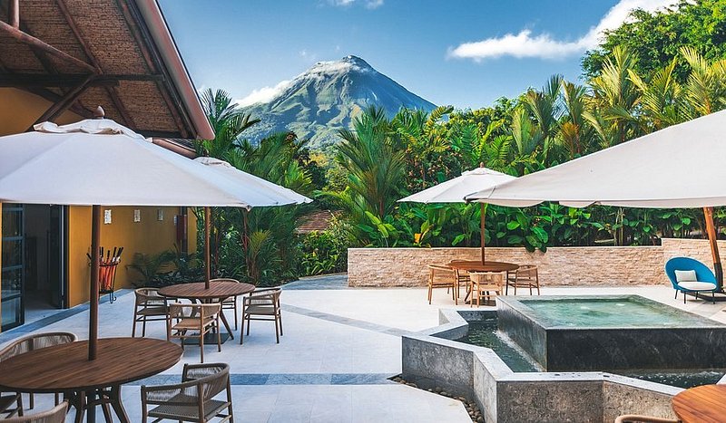 A beautiful jungle hotel terrace with sweeping views of the Arenal Volcano in Costa Rica