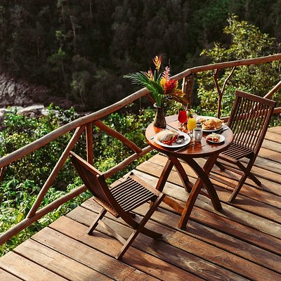 A hearty breakfast served on a wooden patio overlooking a river