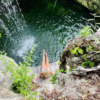 Top-down view of a lady relaxing at KAN Tulum's natural cenote