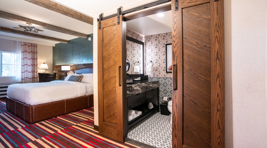 Cowboy Kitsch guest room - Get cozy in our rustic modern haven – where cowboy boots meet plush slippers and comfort meets style! 