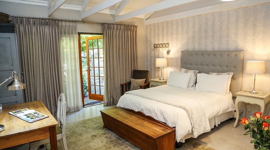 Garden Queen luxury room with double doors opening onto garden. A communal kitchen is available 
