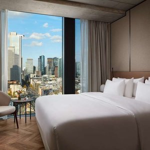 NH Collection Frankfurt Spin Tower Room Superior interior king size bed table chair