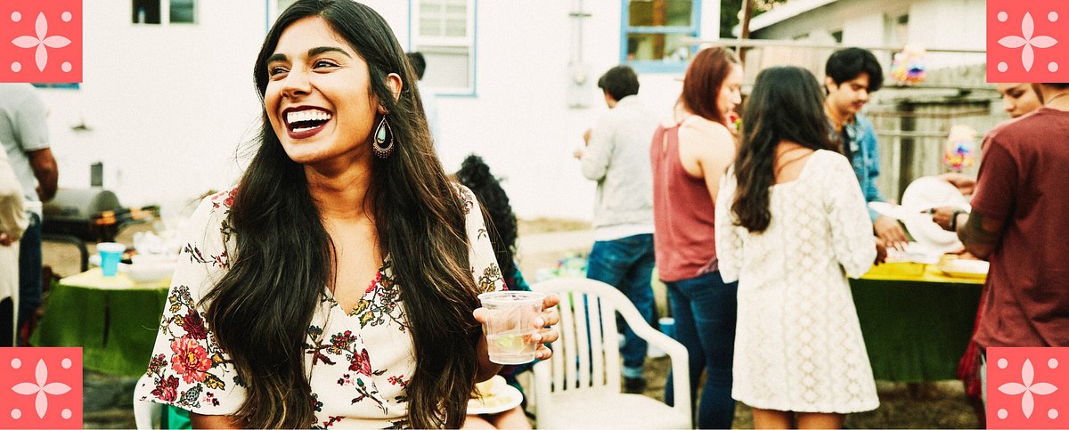 Laughing woman hanging out with friends during backyard party