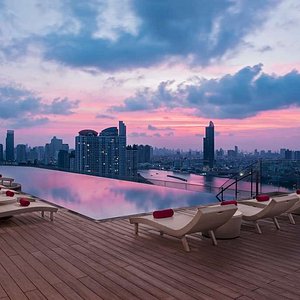 Rooftop swimming pool illuminated by the colours of sunset