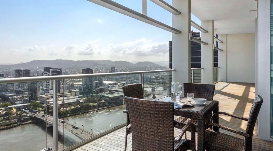 Exterior view of dining area on balcony of Three Bedroom Apartment with river view