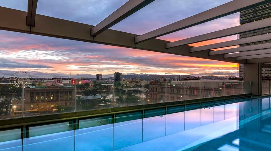 Exterior view of swimming pool with river and city view