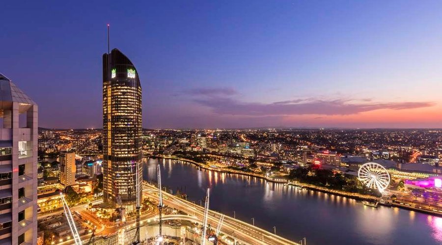Exterior view over river and city at night
