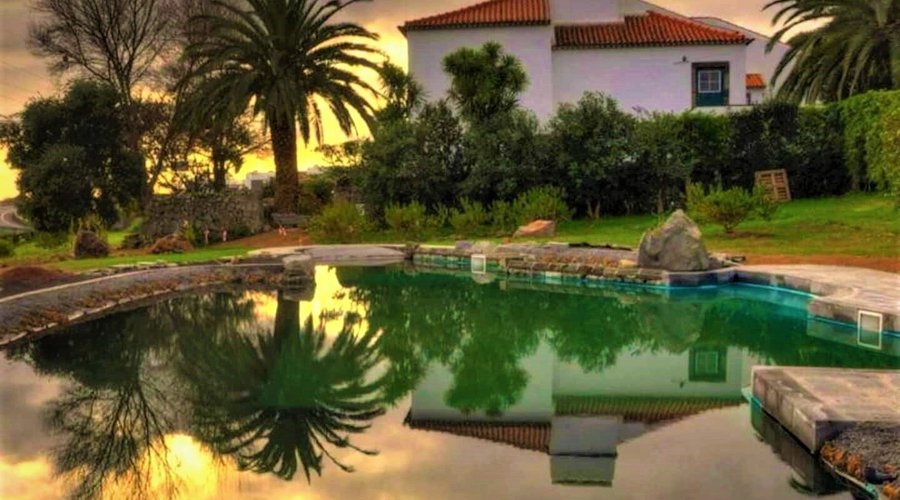 House view from the Natural swimming pool at sunset