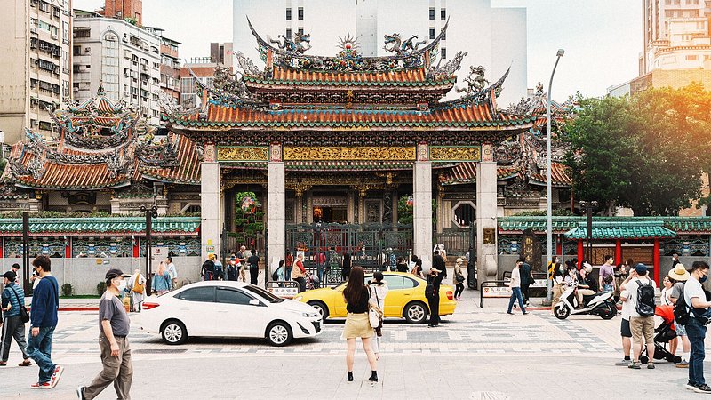 People and traffic outside Longshan Temple, in Taipei