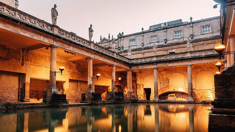The Roman Baths at twilight, surrounded by pillar columns