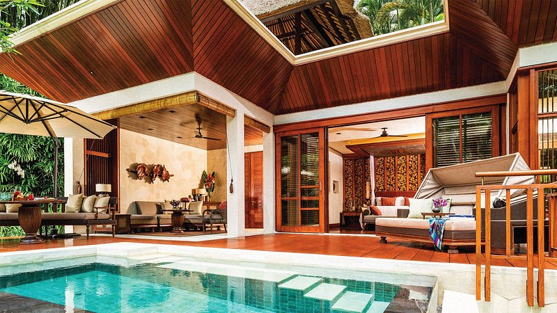 A private open-air villa with an indoor-sized pool that looks out over the jungle beyond