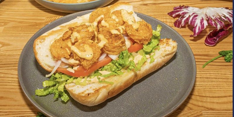 and open-faced sandwich on a wooden table.