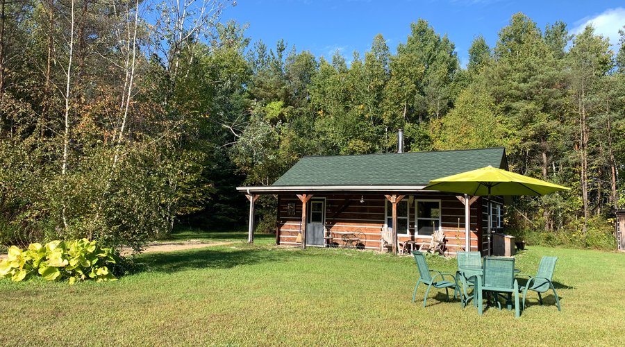 The Hideaway Cabin in the forest clearing.