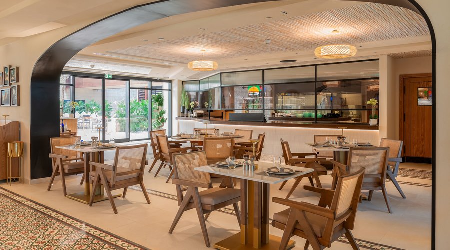 One of the highlights of the restaurant is the open kitchen, which features a charcoal grill and bread oven prominently placed in the center of the space. The clay oven design adds an authentic and traditional touch to the kitchen area, while the open layout allows guests to watch the preparation of their food in real-time. 
