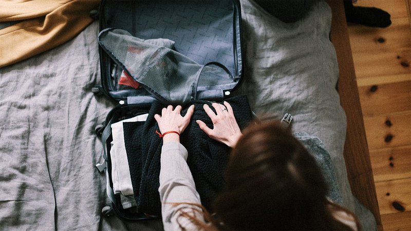 Woman packing suitcase 