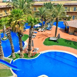 lagoon style swimming pool, with kids pool with slide arial view. 