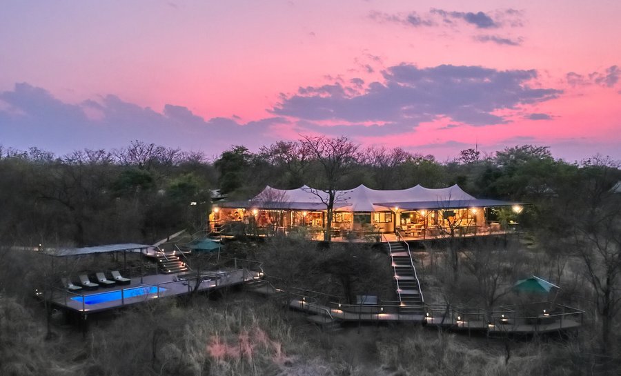 Basking in the Warm Embrace of Victoria Falls: The Elephant Camp at Sunset.