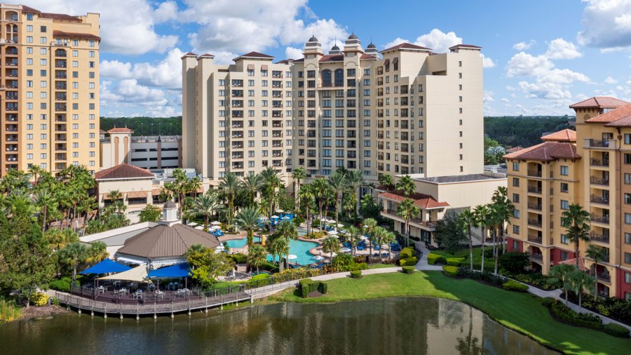 A 10-acre lake with fountains is surrounded by a walkway that connects the Wyndham Grand Orlando Resort Bonnet Creek with surrounding Club Wyndham resorts and their pool amenities.