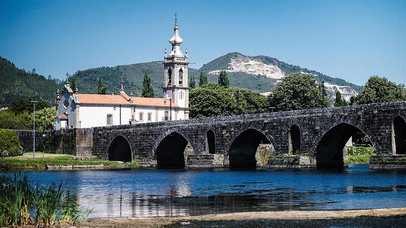View of a long medieval bridge, over the Lima River, in Ponte de Lima, Portugal