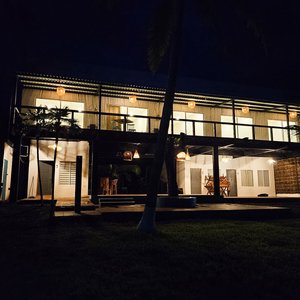 View of the hotel from the pool area at night. Three rooms are located on the first floor, and our deluxe rooms are on the second floor.