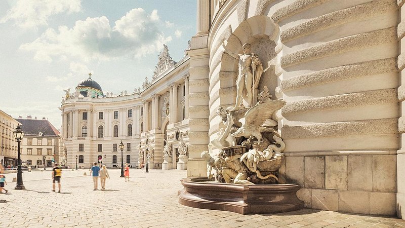 Tourists walking outside of Hofburg Palace, in Vienna
