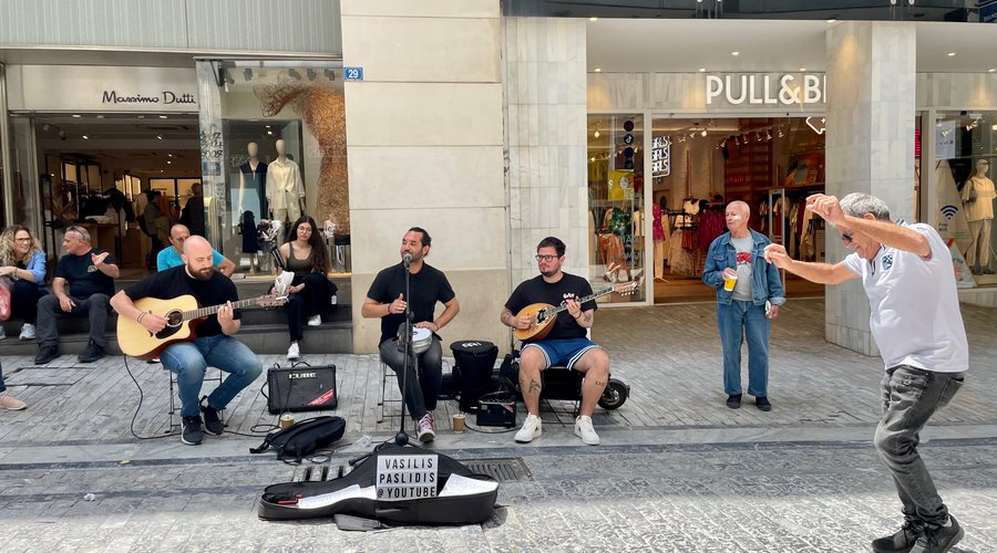 Street entertainers in the popular shopping area of Ermou Street.
