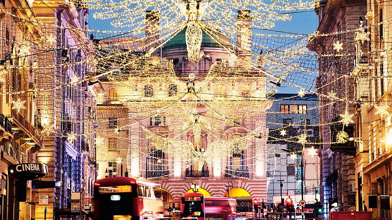 Busy street at Christmas with lights and decorations looking towards Piccadilly Circus