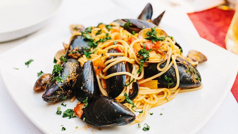 Fresh mussels and seafood with spaghetti in a restaurant in Rome.