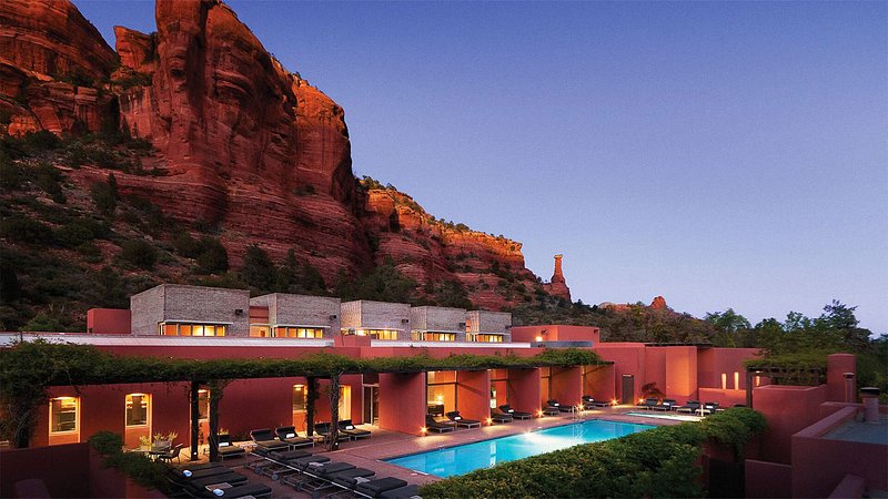 Lanscape view of spa complex with pool set in the shadows of the mountainside