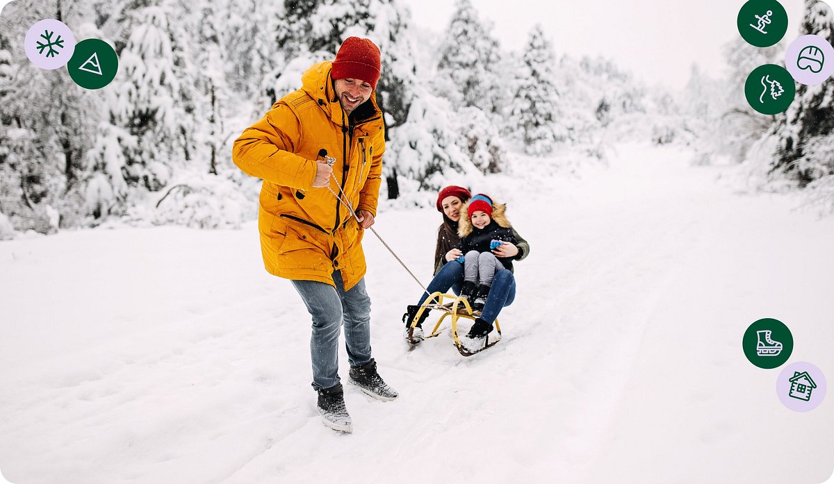 Family sledding down a snowy mountain
