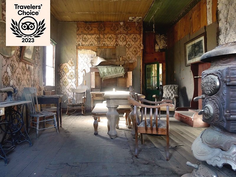 Dilapidated room interior with peeling wallpaper and chairs