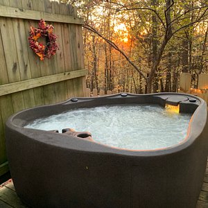 Private guest hot tub with a sunset view