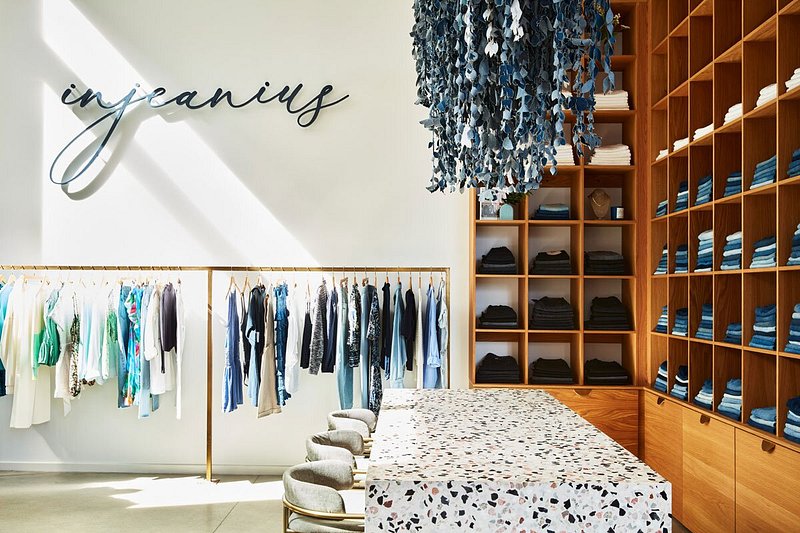 Interior of store with shelves of jeans and hanging clothes