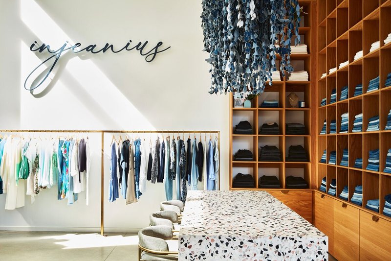 Interior of store with shelves of jeans and hanging clothes