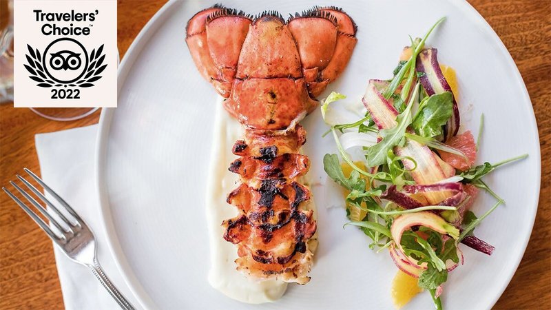 Lobster tail next to salad