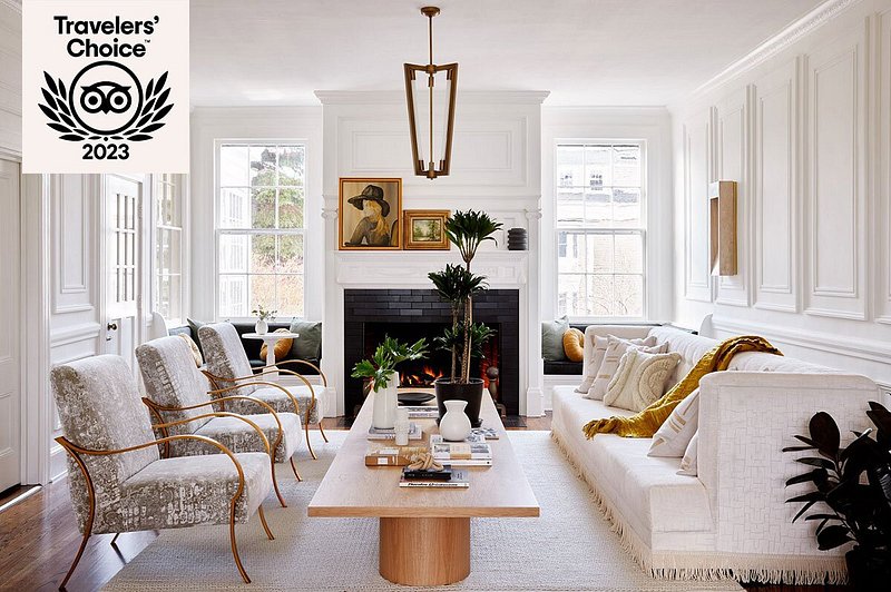 White-painted living area with fireplace, couch, and chairs