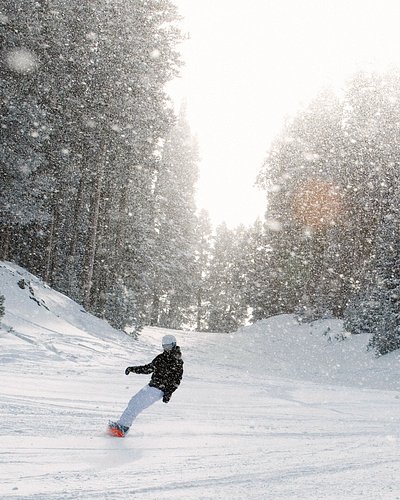 Skier heads down snowy slopes