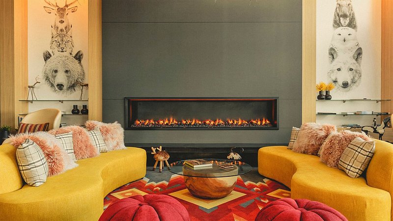 A colorful hotel lobby decorated in animal prints and a mounted fireplace