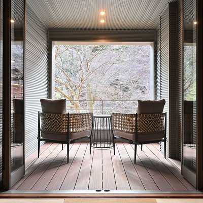 A hotel room with a private deck facing the forest in Shima Onsen Tokiwasure no Yado Yoshimoto.