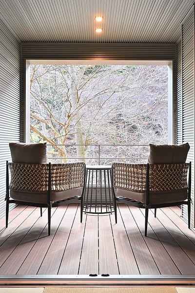 A hotel room with a private deck facing the forest in Shima Onsen Tokiwasure no Yado Yoshimoto