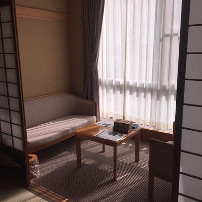 Interior of a room with a cozy seating area and soft lighting in Ryokan Sakaya.