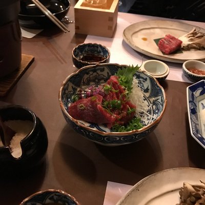 Travelers having a Kaiseki dinner (traditional multi-course Japanese meal) at Ryokan Sakaya.