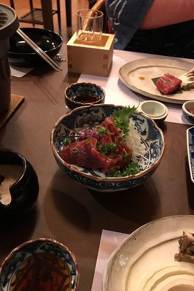 Travelers having a Kaiseki dinner (traditional multi-course Japanese meal) at Ryokan Sakaya