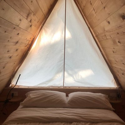 Interior view of a cozy Lushna-style cabin at Eastwind Hotel & Bar