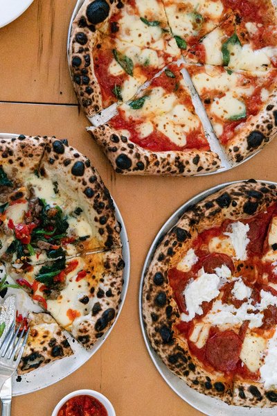 Three pizzas on a table at The Dolphin Hotel