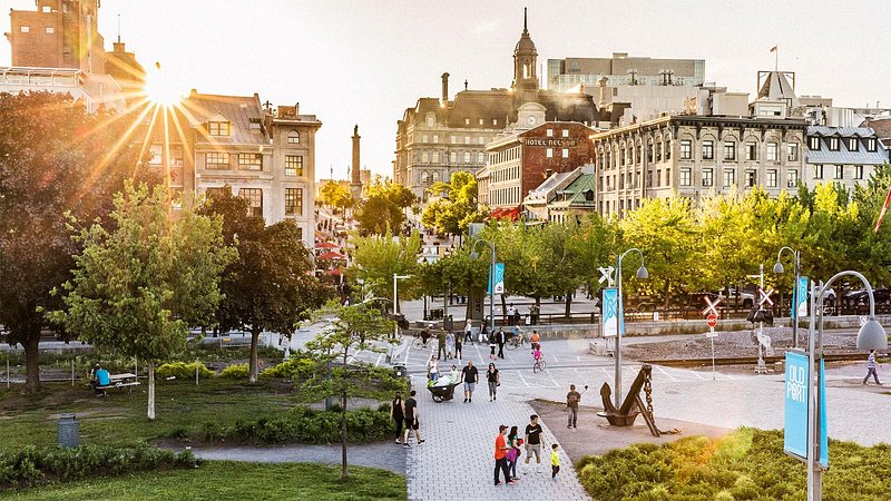 Tourists walking through Place Jacques Cartier, in Montreal, in the morning