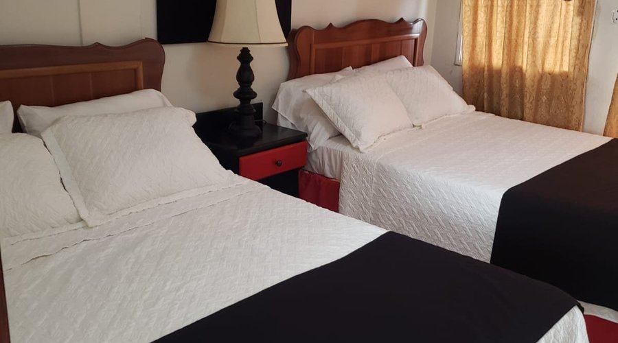 Standard Room  2 Double bed, Air conditioning, private bath, hot and cold water, Tv, Wifi, fridge and Balcony Located on the side of the building with a balcony.
