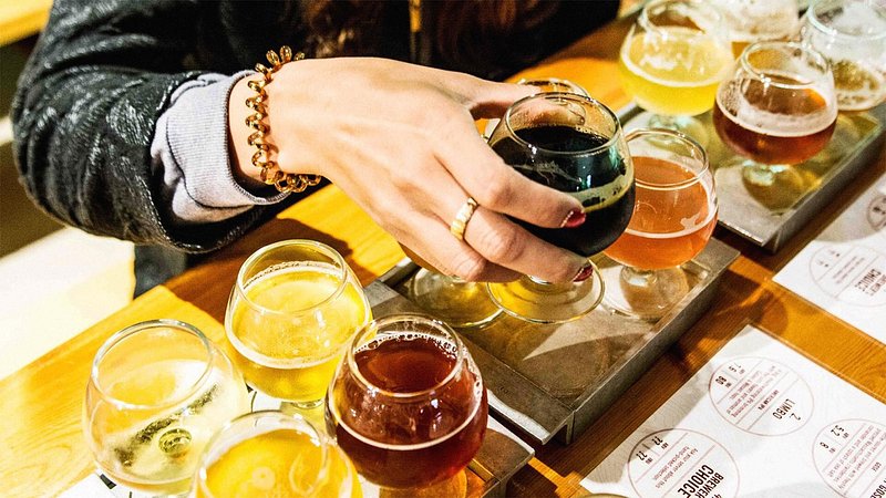 Person enjoying beer flight at Long Trail Brewing Company, Vermont