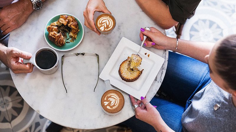 Overhead view of coffee and pastries at Kona Coffee Purveyors