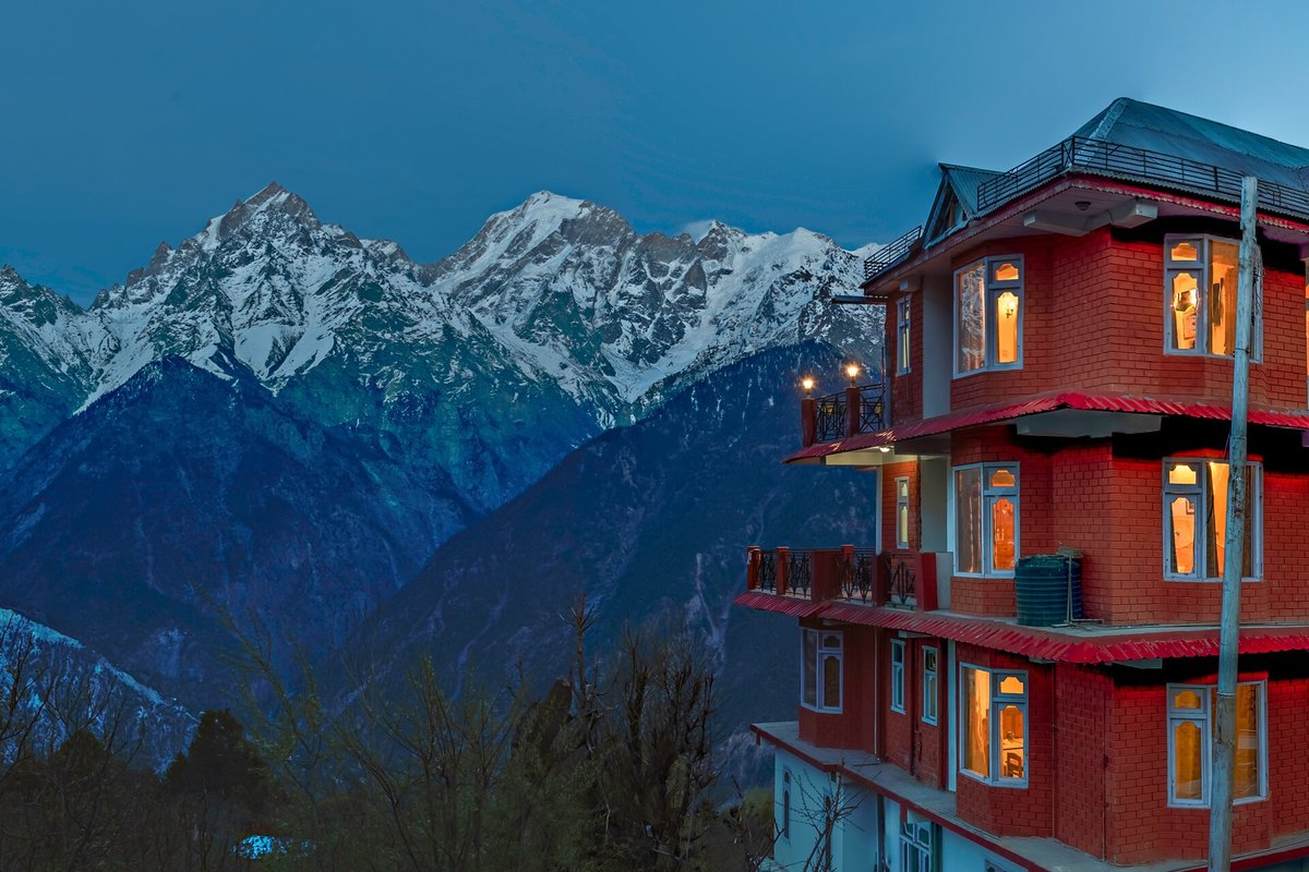 A picturesque homestay blanketed in snow, offering breathtaking winter views of the Himalayas.